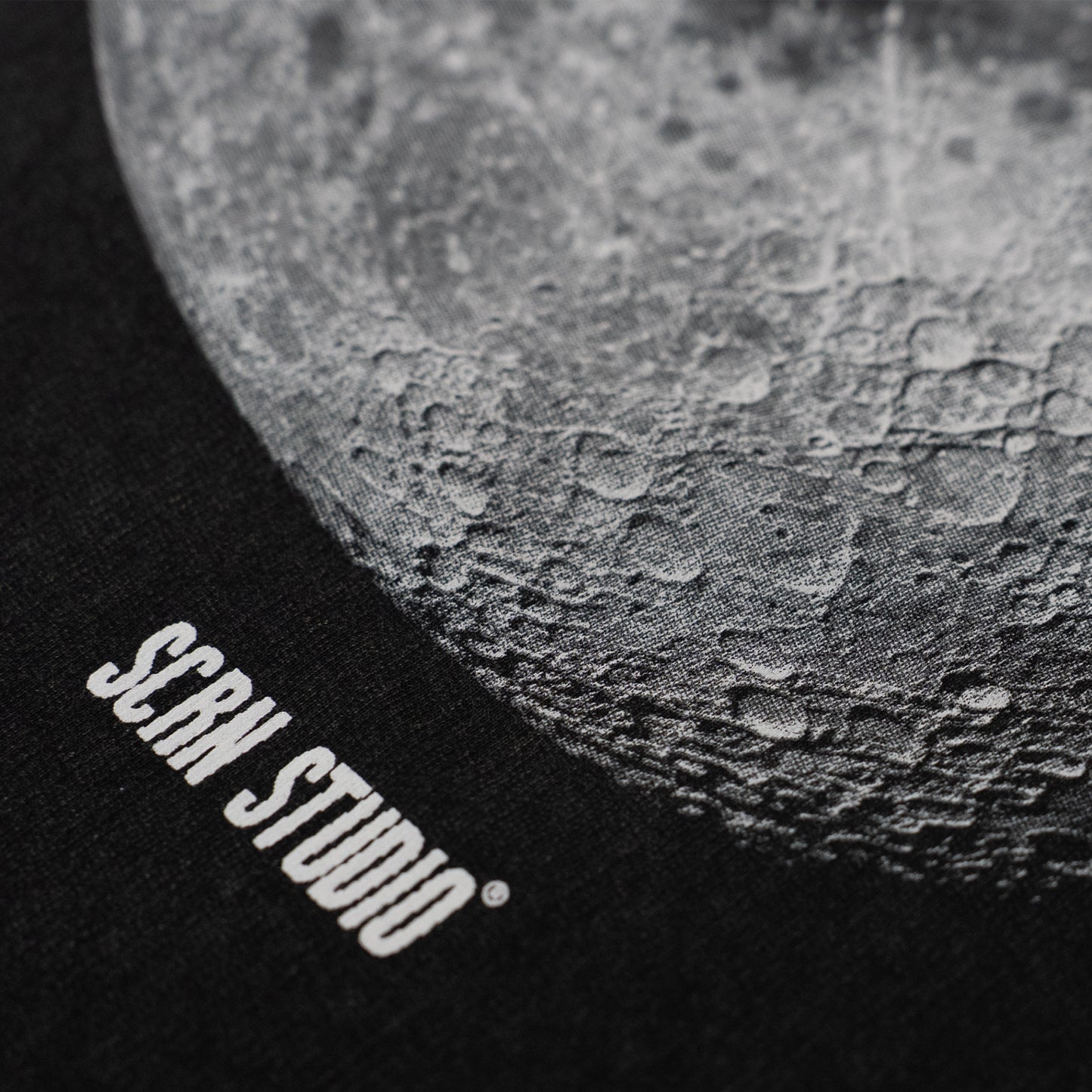 Close-up of a textured surface with 'SCRN STUDIO' branding.