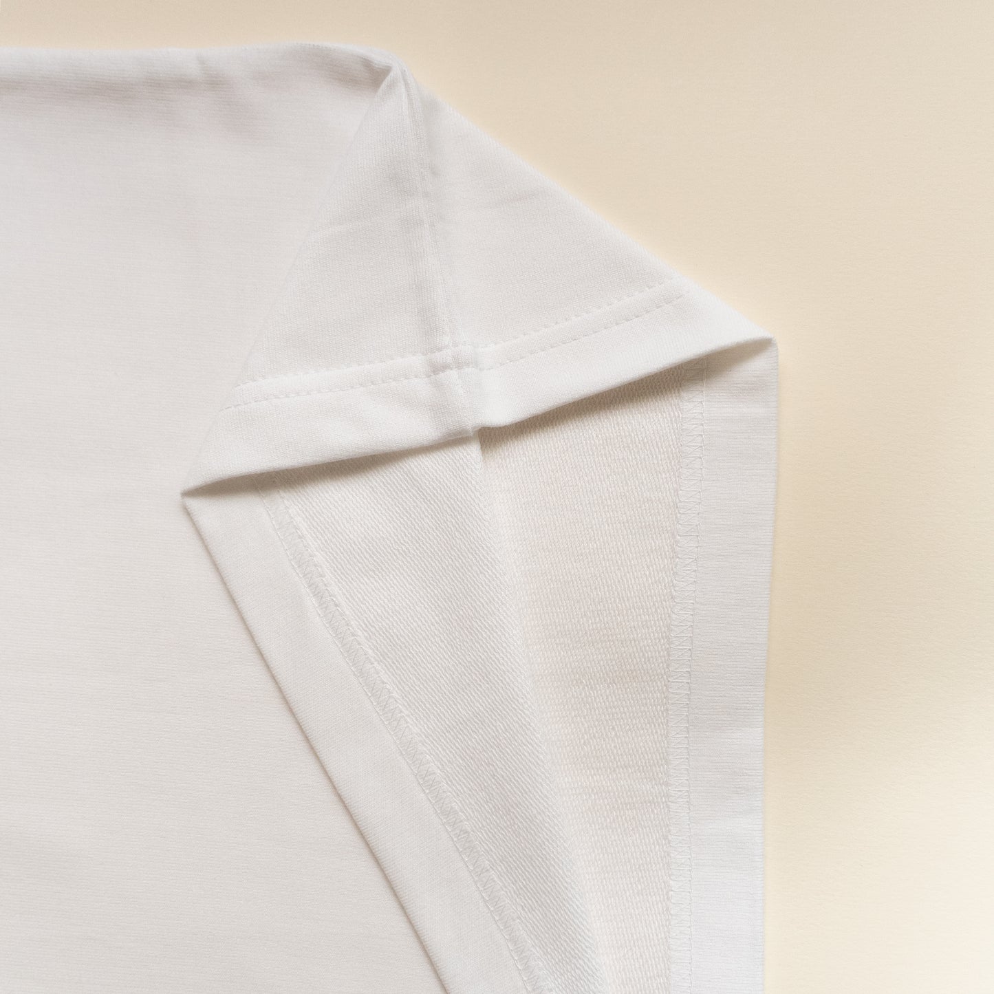 Close-up of a white tshirt on a beige background
