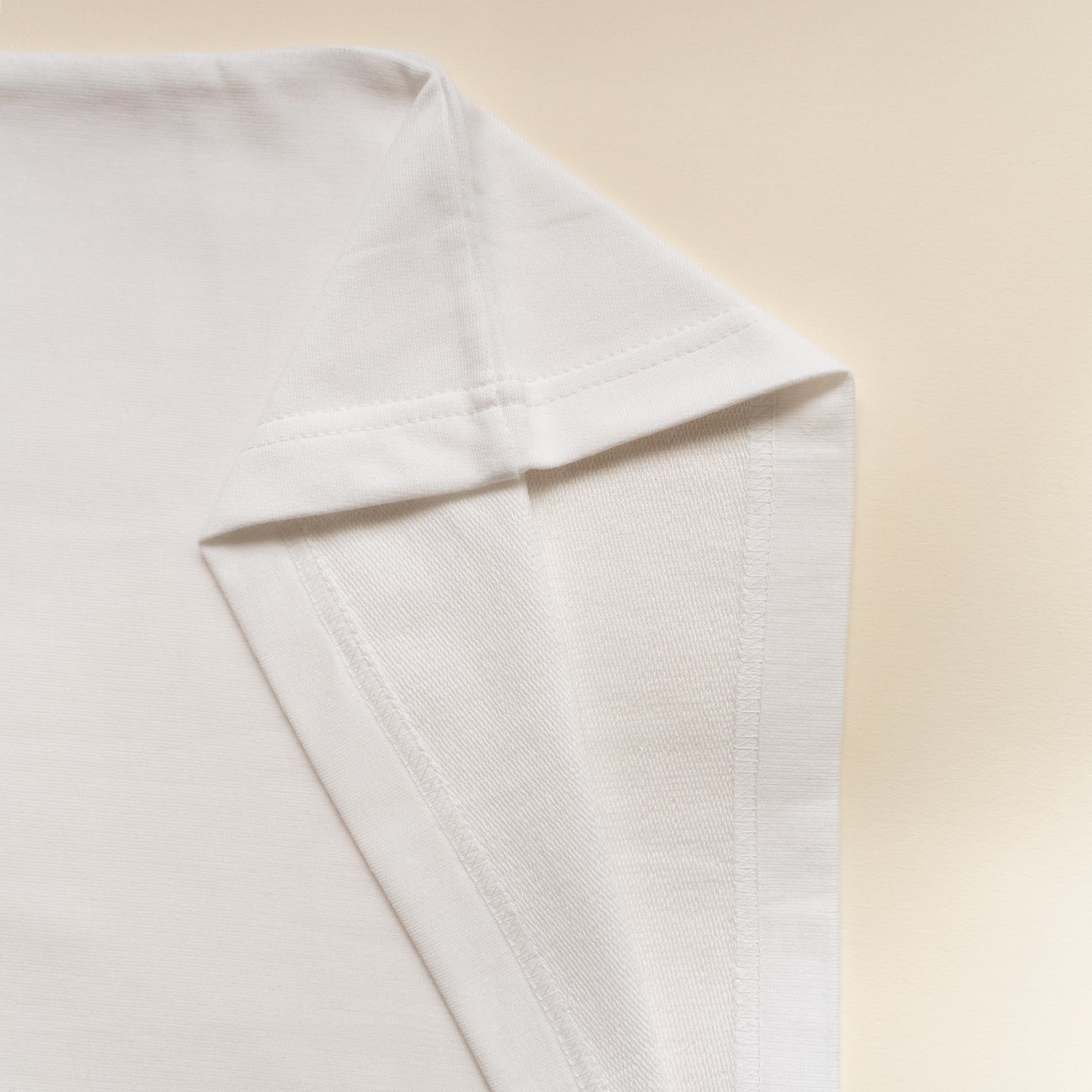 Close-up of a white tshirt on a beige background