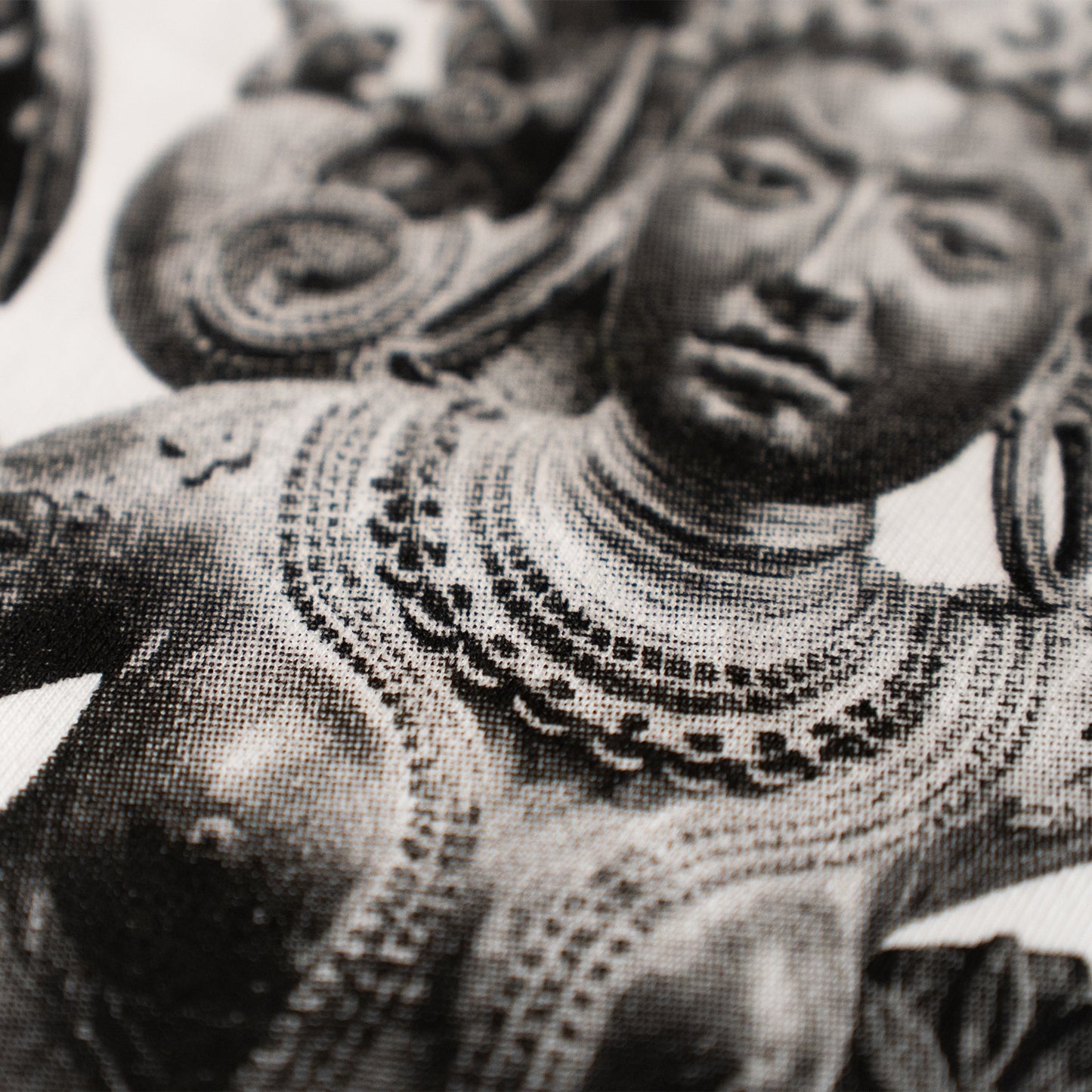 Black and white statue of a person wearing intricate jewelry