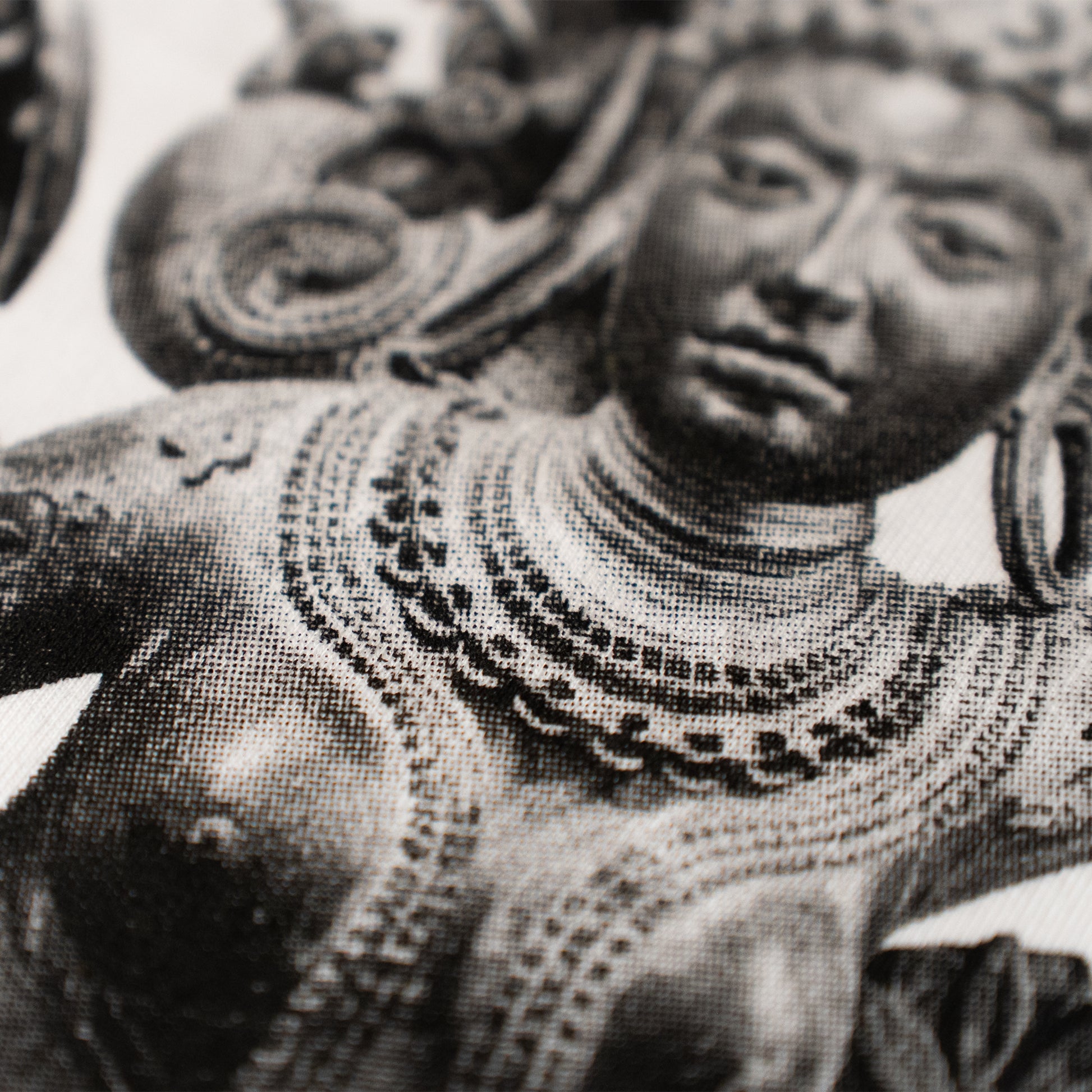 Black and white statue of a person wearing intricate jewelry