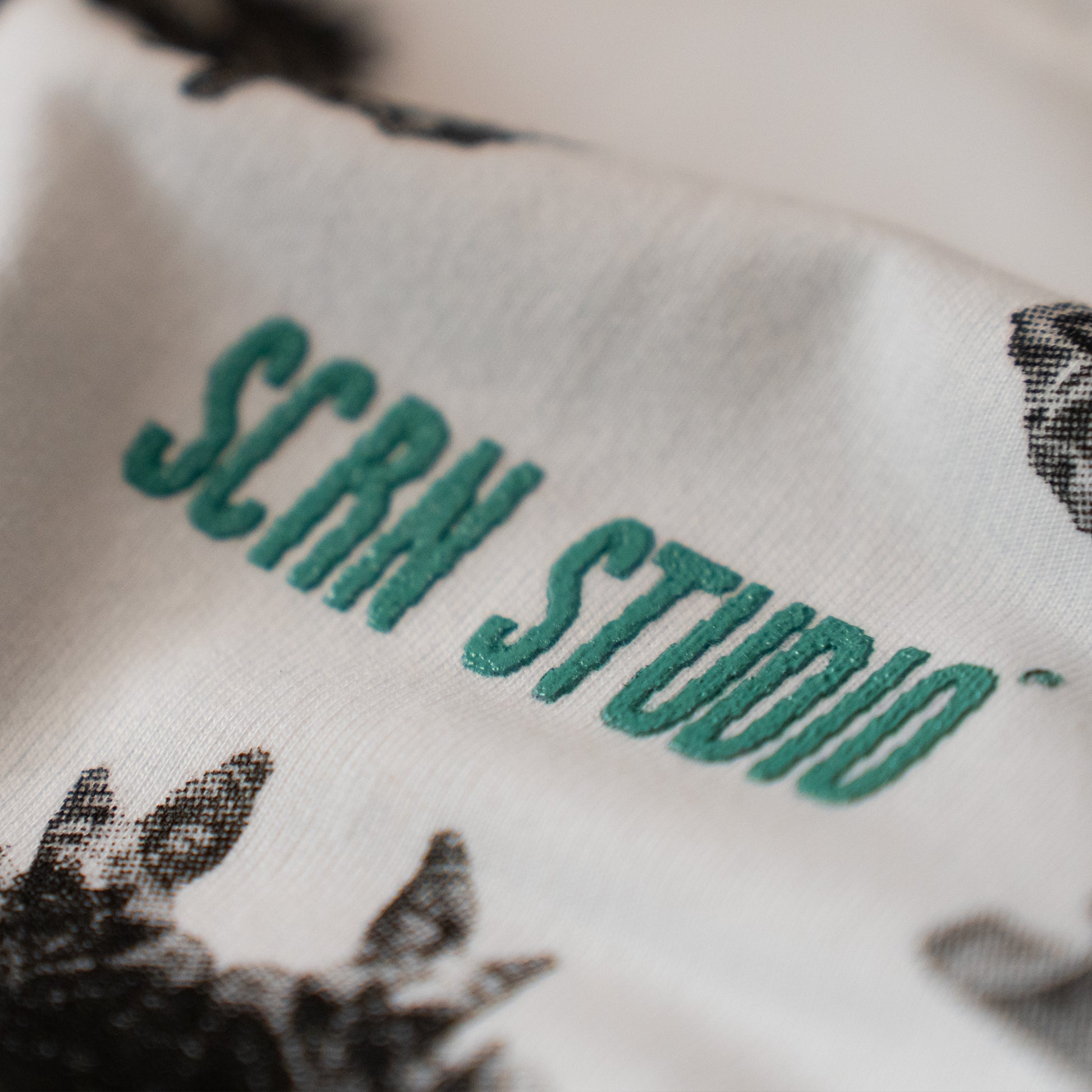 Close-up of a product with 'SCRN Studio' text on a white background